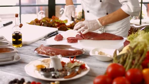 Chef Cutting Raw Meat for Dish Preparation