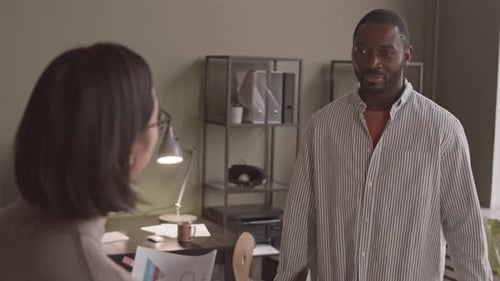 African-American Man Talking to Colleague in Office