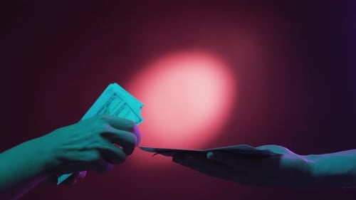 Money Exchange Under Futuristic Lighting