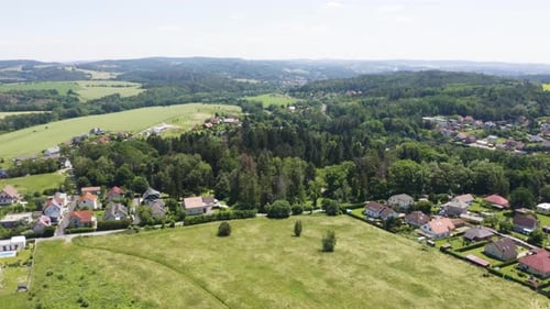 Aerial Drone Shot Colorful Houses in a Beautiful Town with a Forest in the Middle in a Rural Area