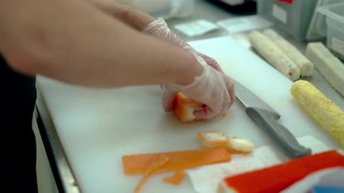 Cook Serves a Japanese Roll with Salmon