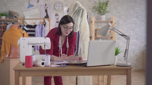 Female Fashion Designer Sketching in Her Studio
