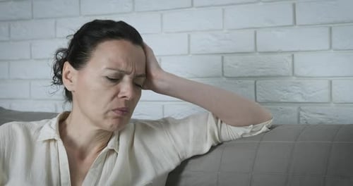 Woman feeling stress at home.