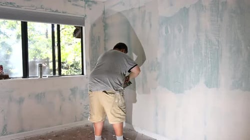 Man Spackling an Interior Wall