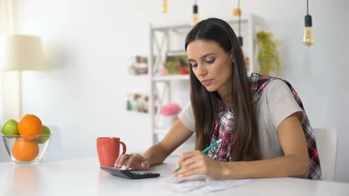 Young Lady Planning Home Budget, Counting Incomes and Expenses, Saving Money