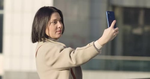 Woman Talking on Phone Outdoors in City