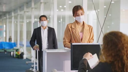 Woman Checks in at Airport Counter with Face Mask