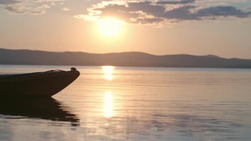 Kayaker Paddling on Calm Lake at Sunset