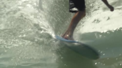Surfer Riding Wave on Blue Surfboard, Close-Up