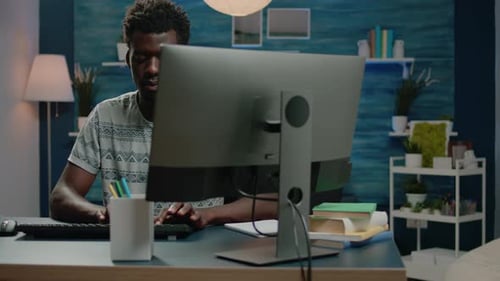 Man Typing at Computer in Home Office