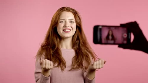 Smiling Woman Recording Video on Smartphone