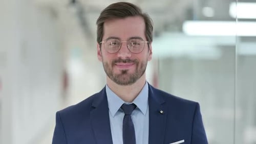 Smiling Businessman in Suit and Glasses