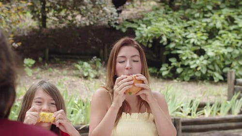 Woman and Child Enjoying Outdoor Meal