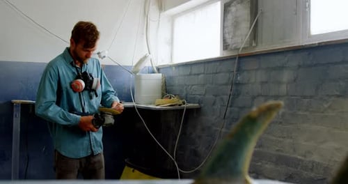 Man making surfboard 4k