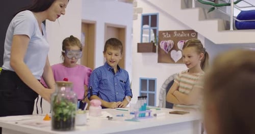 Elementary School Science Classroom Enthusiastic Teacher Explains Chemistry to Diverse Group of