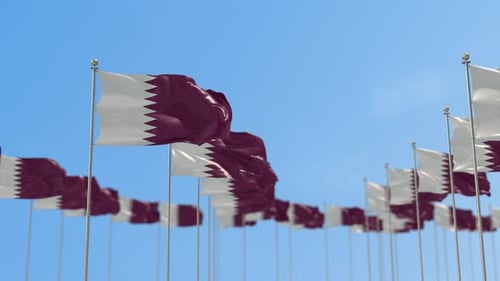 Multiple Realistic Qatar Flags Waving on Flagpoles Against Blue Sky