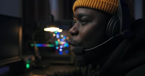 Young Adult Using Computer in Dark Room