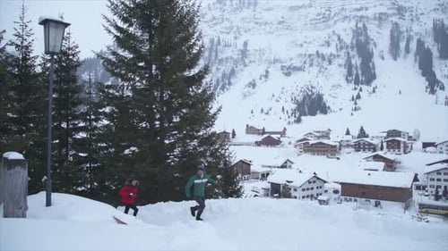 A man and woman couple having a playful snowball fight lifestyle in the snow at a ski resort
