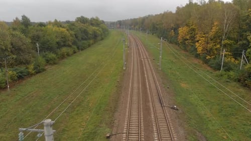 Flying Over the Rails of Railway in Wooded Area