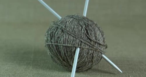 Brown Yarn with Knitting Needles Close Up