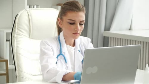 Portrait of Female Doctor Works at Laptop in Clinic Medicine and Healthcare Concept