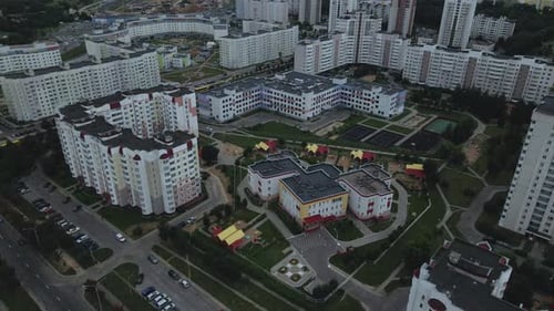 City block. Modern multi-storey buildings. Flying at dusk at sunset.