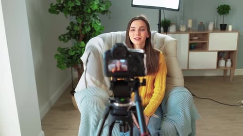 Woman Vlogging to Camera Indoors in Bright Room