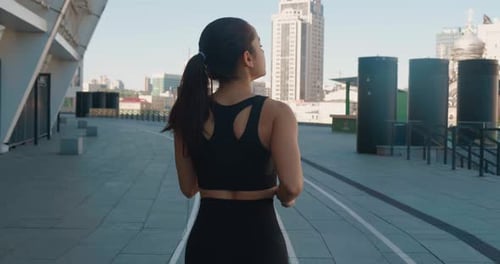 Rear Back View of Athletic Young Woman Jogging Outdoors in Slow Motion
