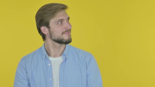 Young Adult Smiling and Pointing to the Right