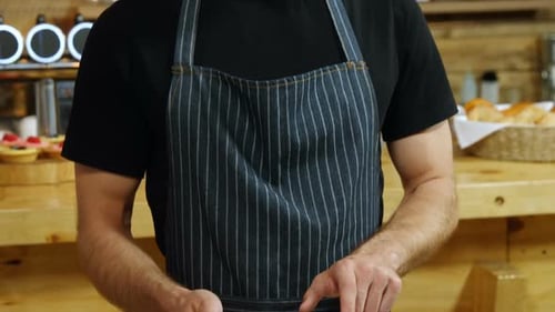 Waiter using digital tablet in cafe