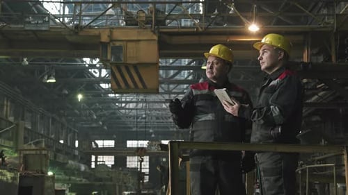 Tractor Plant Workers Having Conversation