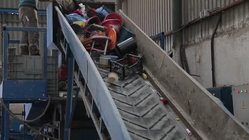 Plastic Waste on Conveyor Belt at Recycling Plant