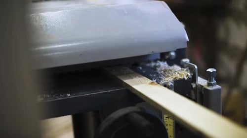Plank of Wood Going Through Planing Machine
