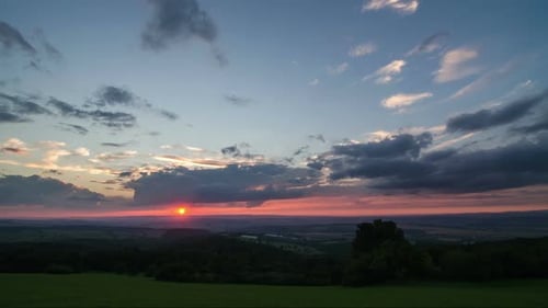 Dramatic Sunset over Green Countryside Landscape