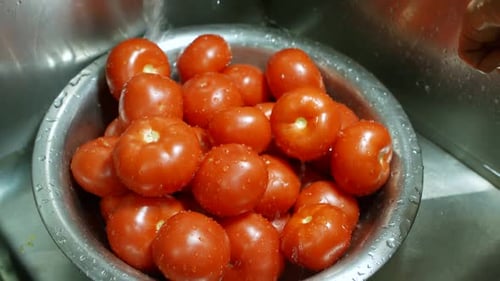 Fresh Tomatoes Being Washed in Kitchen Sink