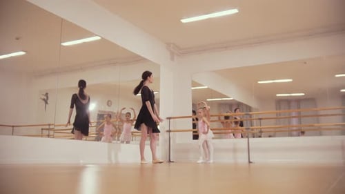 Ballet Instructor Teaching Young Girls in Dance Studio