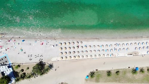 Scenic Beach with Turquoise Water and Straw Umbrellas