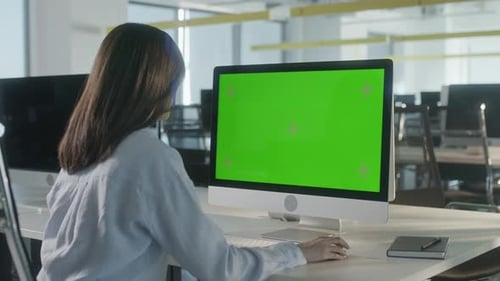 Woman Works at Computer with Chroma Key Screen