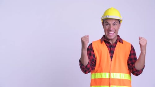 Construction Worker Celebrating Success with Fists Up