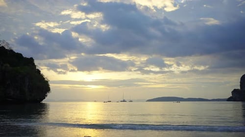 4K Timelapse of Asian man and woman paddle boarding in the sea together at summer sunset.