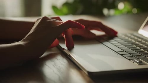 Close Up of a Woman Hand Scrolling on a Laptop Computer Touchpad in Slow Motion