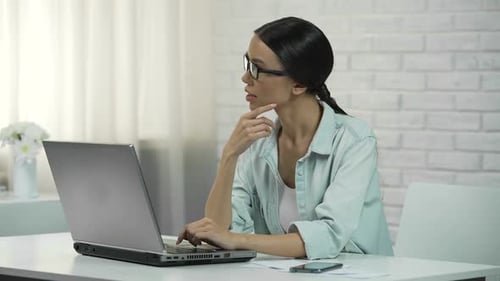 Young Asian Woman Typing on Laptop Writing Flirty Message on Dating Website