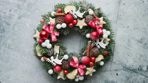 Christmas Green, Red and Golden Wreath with Decorations Isolated on Stone Background
