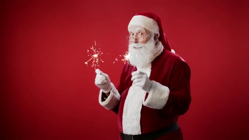 Cheerful Santa Claus Holding Sparklers on Red Background