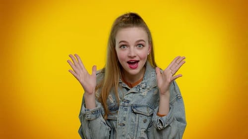 Surprised Blonde Woman Gesturing Against Yellow Background