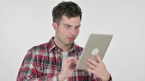 Man Interacts With Tablet, Shows Shocked Facial Expression