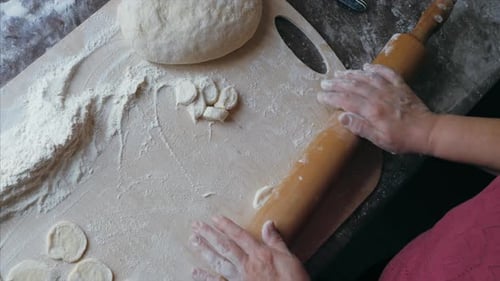 Making Dough with Rolling Pin on Cutting Board