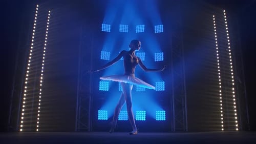 Elegant Ballerina Dancing on Stage with Blue Spotlights