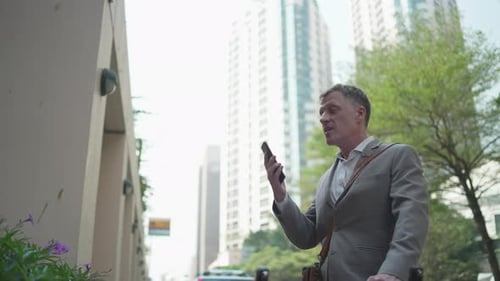 Businessman Talking on Phone in City