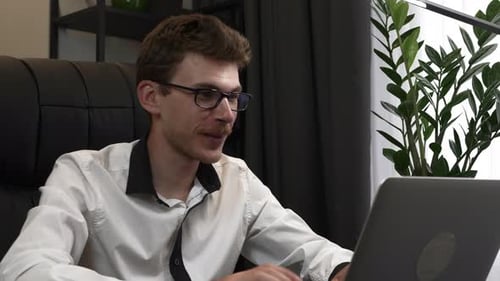 Adult Man Working Remotely at Laptop